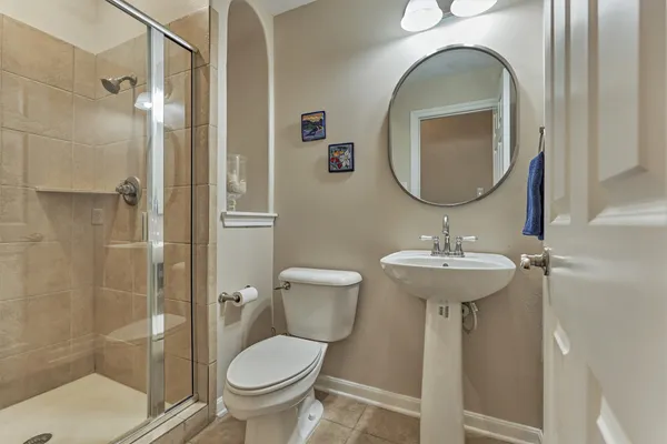 a bathroom with a toilet sink and shower