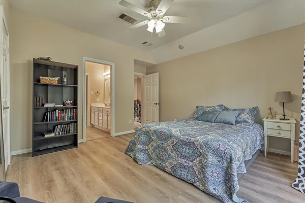 a bedroom with a bed and a chandelier