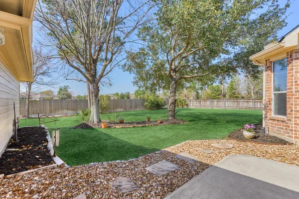 a view of yard with grass and trees