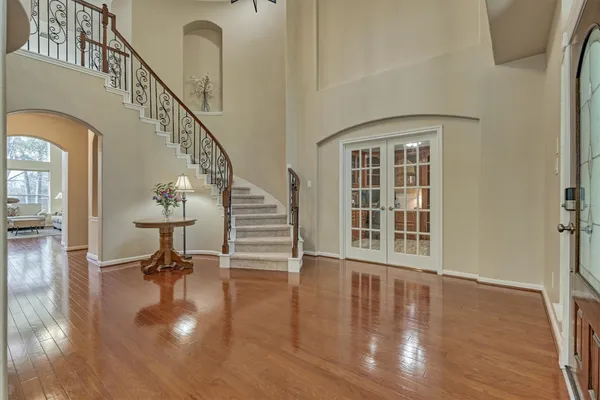a view of entryway and hall with wooden floor