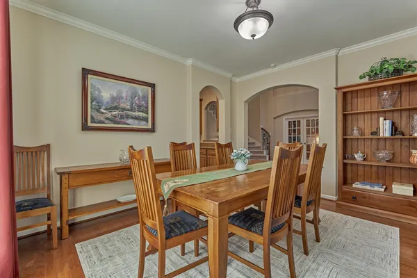 a view of a dining room with furniture and a book shelf