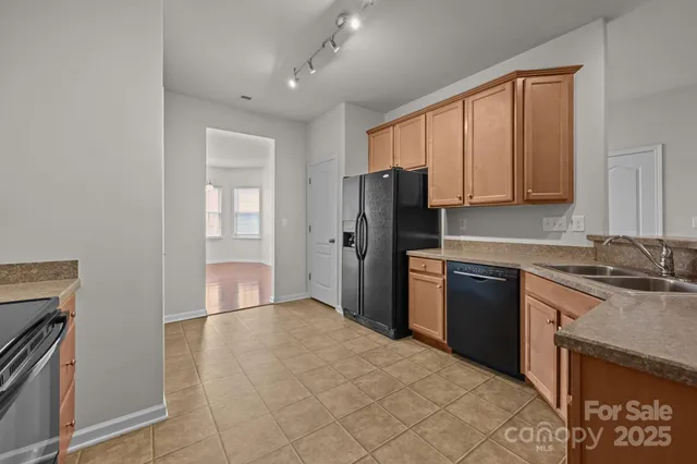 a kitchen with stainless steel appliances granite countertop a stove top oven a sink dishwasher and a microwave oven on the blue kitchen countertops