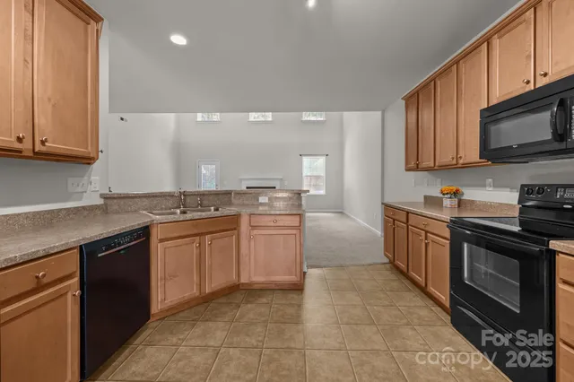 a kitchen with stainless steel appliances granite countertop a stove and a microwave