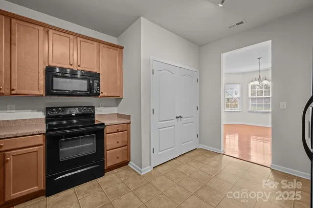 a kitchen with refrigerator and cabinets