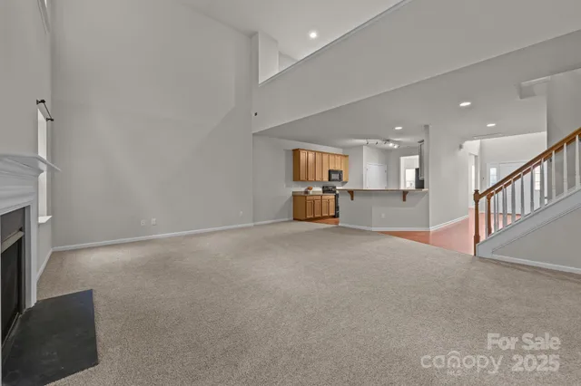 a view of an empty room with a ceiling fan