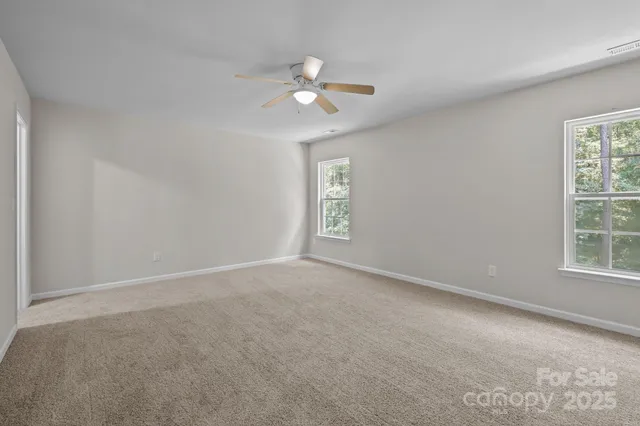 a view of an empty room and a window