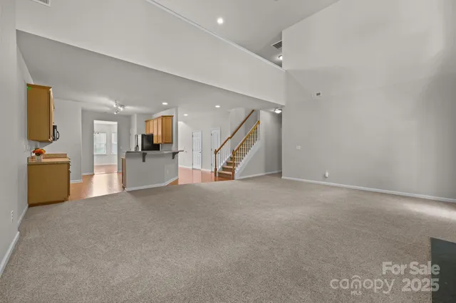 a view of an empty room with a kitchen
