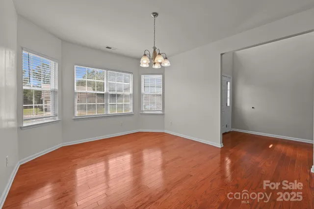 a view of an empty room with windows