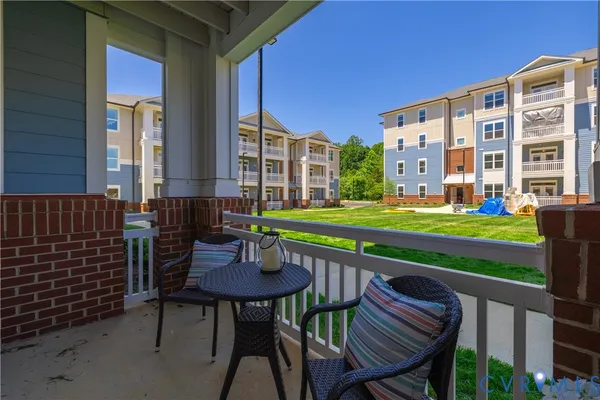 a backyard of a house with barbeque oven table and chairs