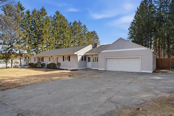 a kitchen with stainless steel appliances a refrigerator a stove a sink a dining table and chairs