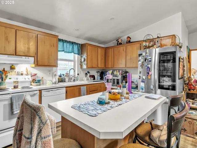 a kitchen with a table chairs and a refrigerator
