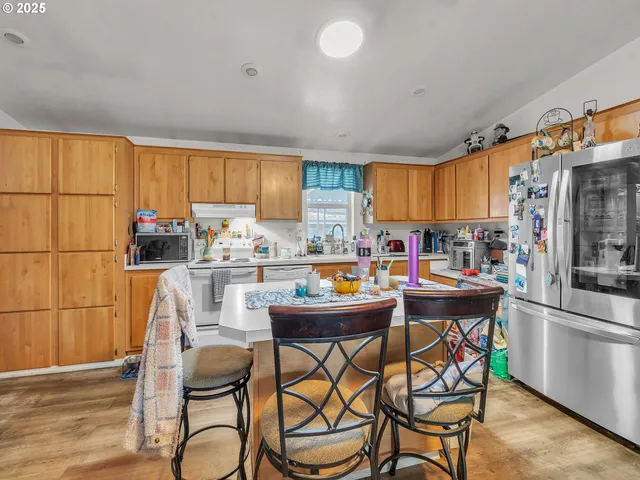 a kitchen with a dining table and chairs