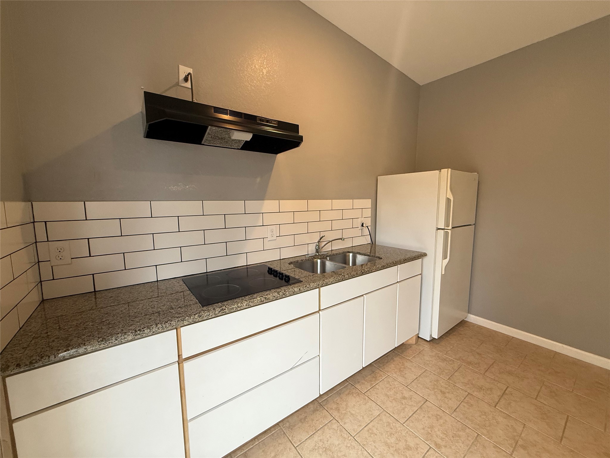 a kitchen with a sink and cabinets