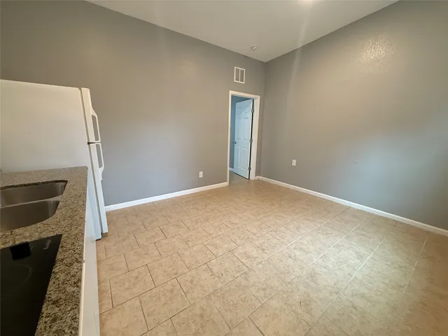 a view of an empty room with a fireplace