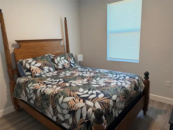 a bed sitting in a bedroom next to a window