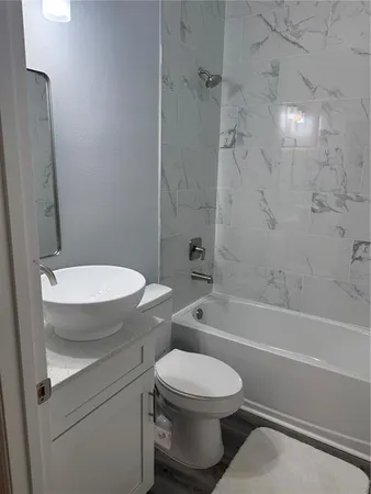 a bathroom with a toilet and a bath tub