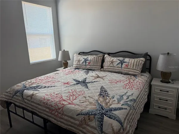 a bedroom with a bed and a window