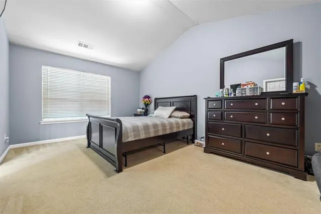 a bedroom with a bed and a tv on table