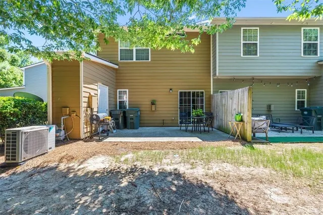 a view of a house with backyard and sitting area