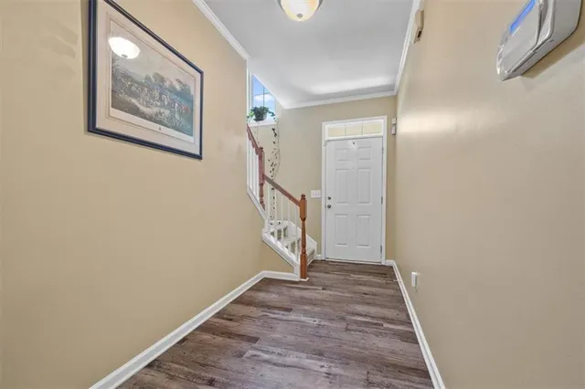 a view of an entryway with wooden floor