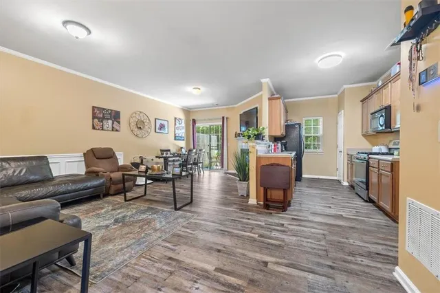 a living room with furniture and kitchen view