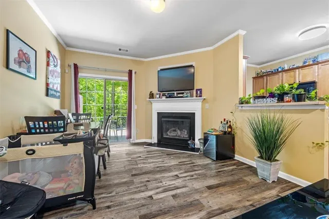 a living room with furniture a fireplace and a flat screen tv