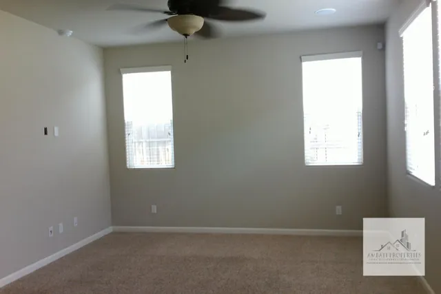an empty room with closet and entryway