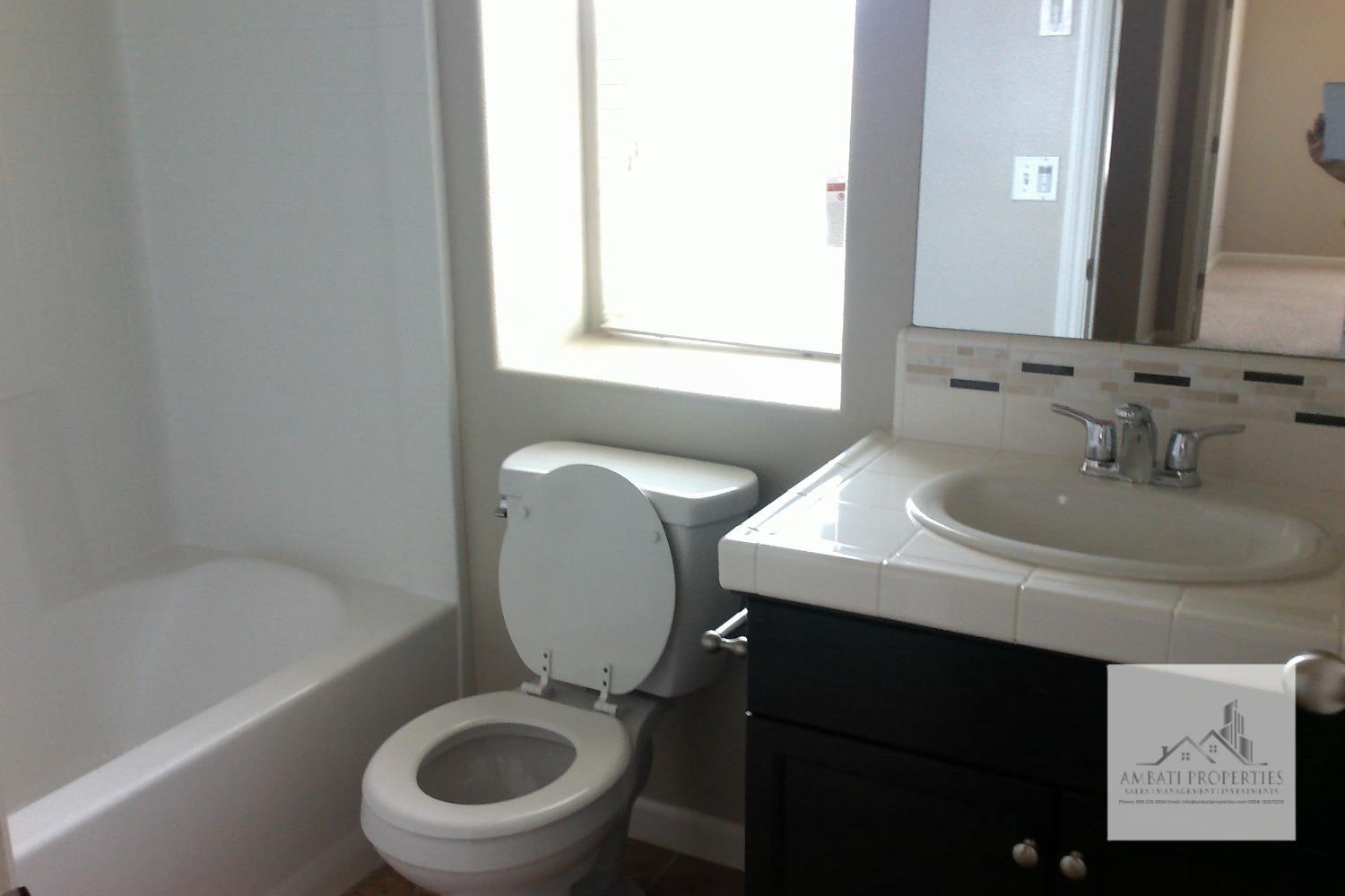 3539 Luminary Way Clovis, CA 93619 - Photo 10 of 13 a bathroom with a sink a toilet and a bathtub