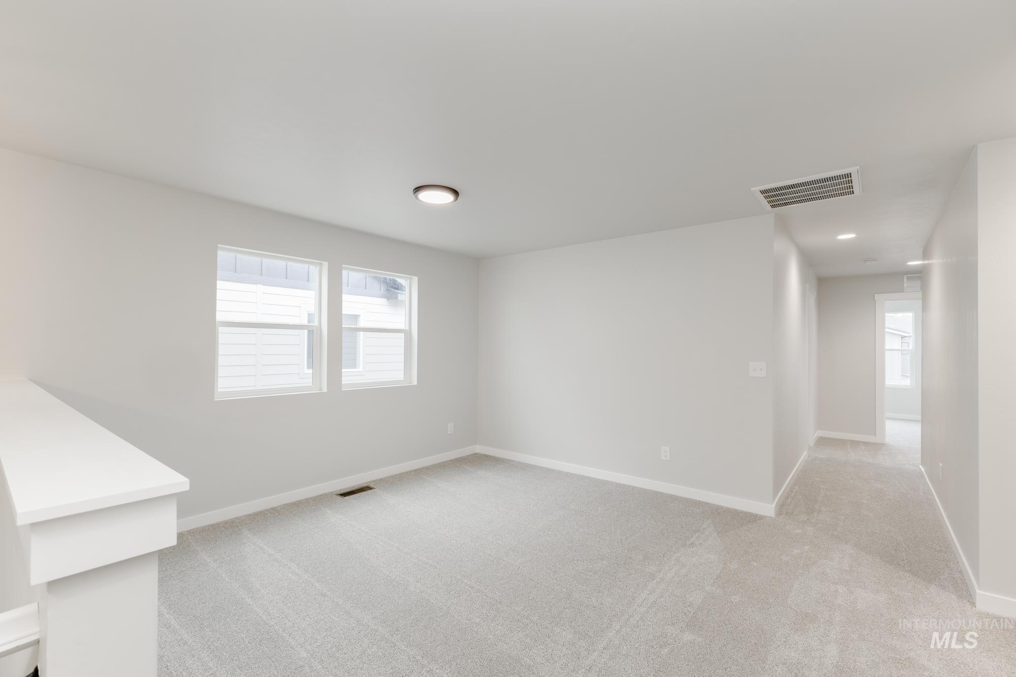 903 North Mirror Creek Way Meridian, ID 83642 - Photo 12 of 24 Unfurnished room featuring light colored carpet