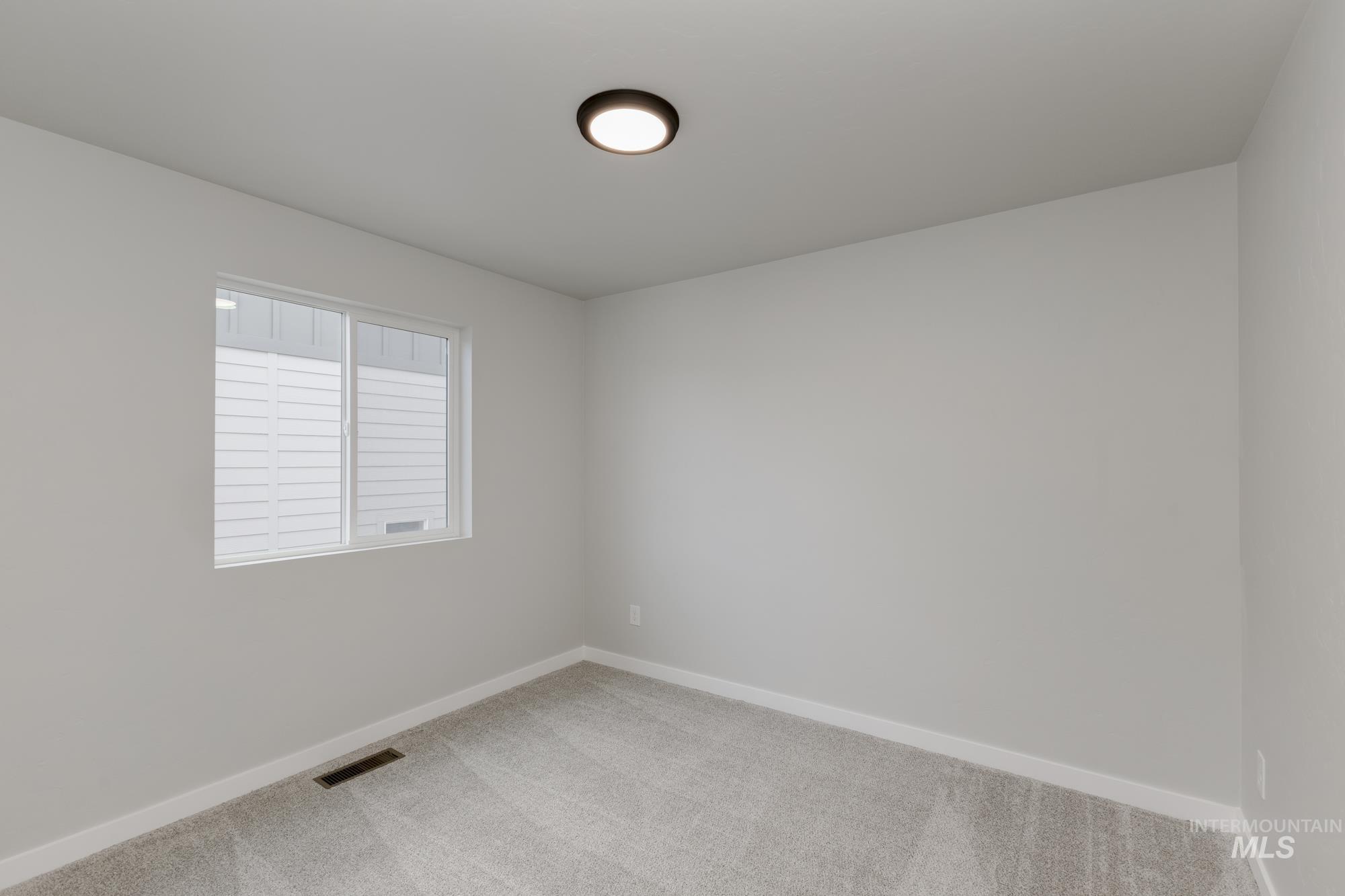 903 North Mirror Creek Way Meridian, ID 83642 - Photo 15 of 24 Carpeted empty room with baseboards