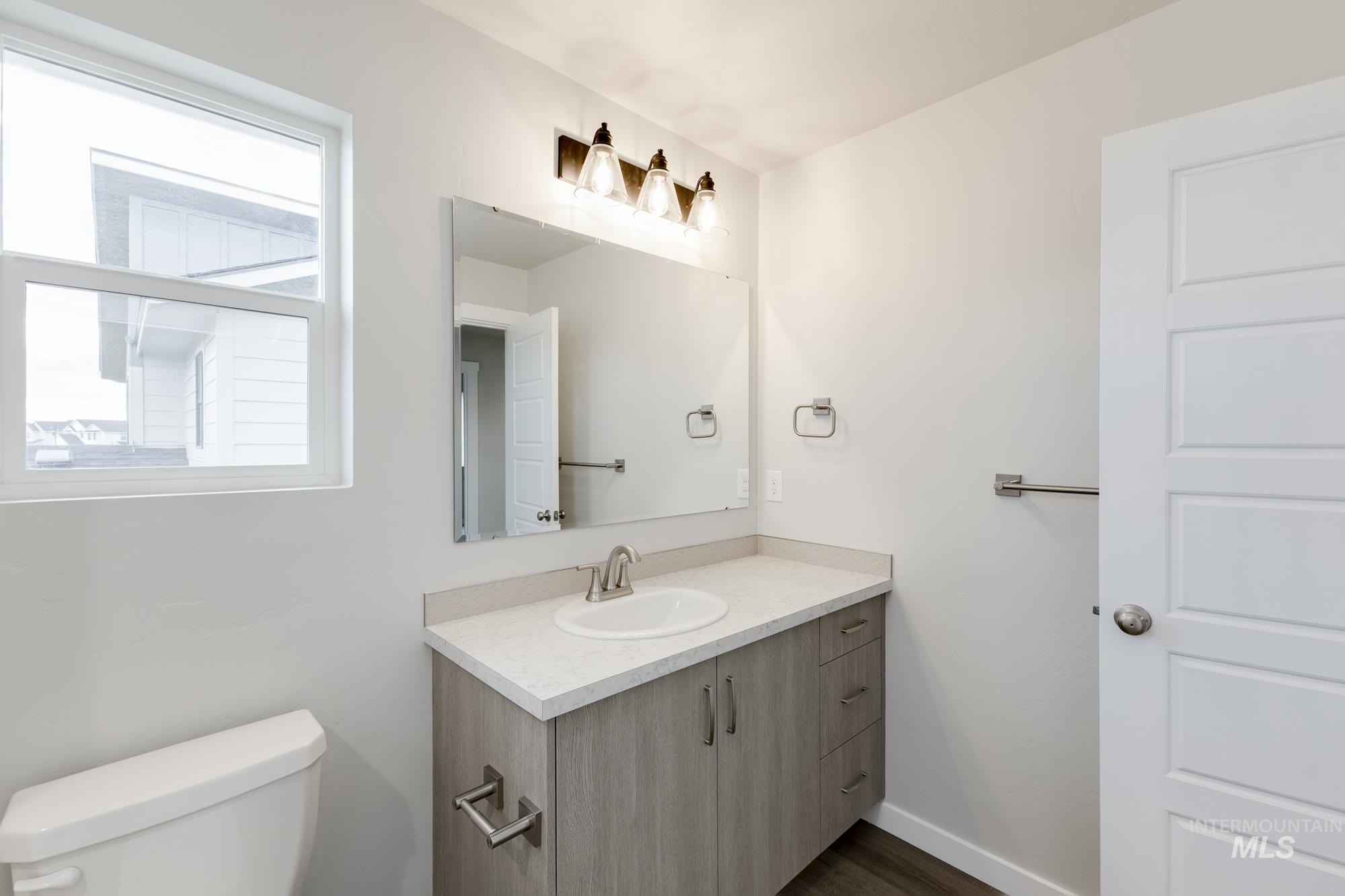 903 North Mirror Creek Way Meridian, ID 83642 - Photo 16 of 24 Bathroom with vanity and dark wood-style flooring