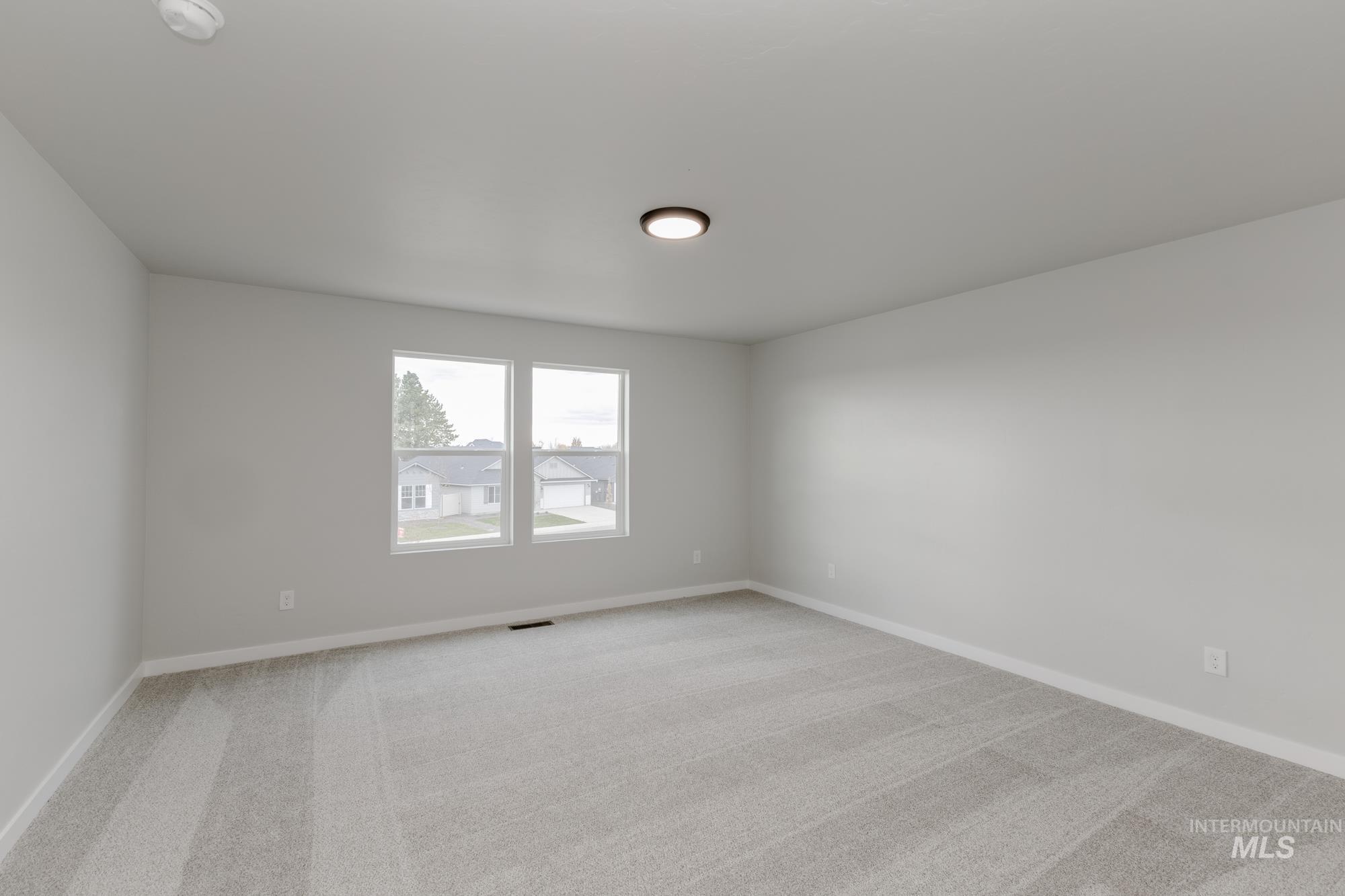 903 North Mirror Creek Way Meridian, ID 83642 - Photo 19 of 24 Unfurnished room featuring light carpet and baseboards