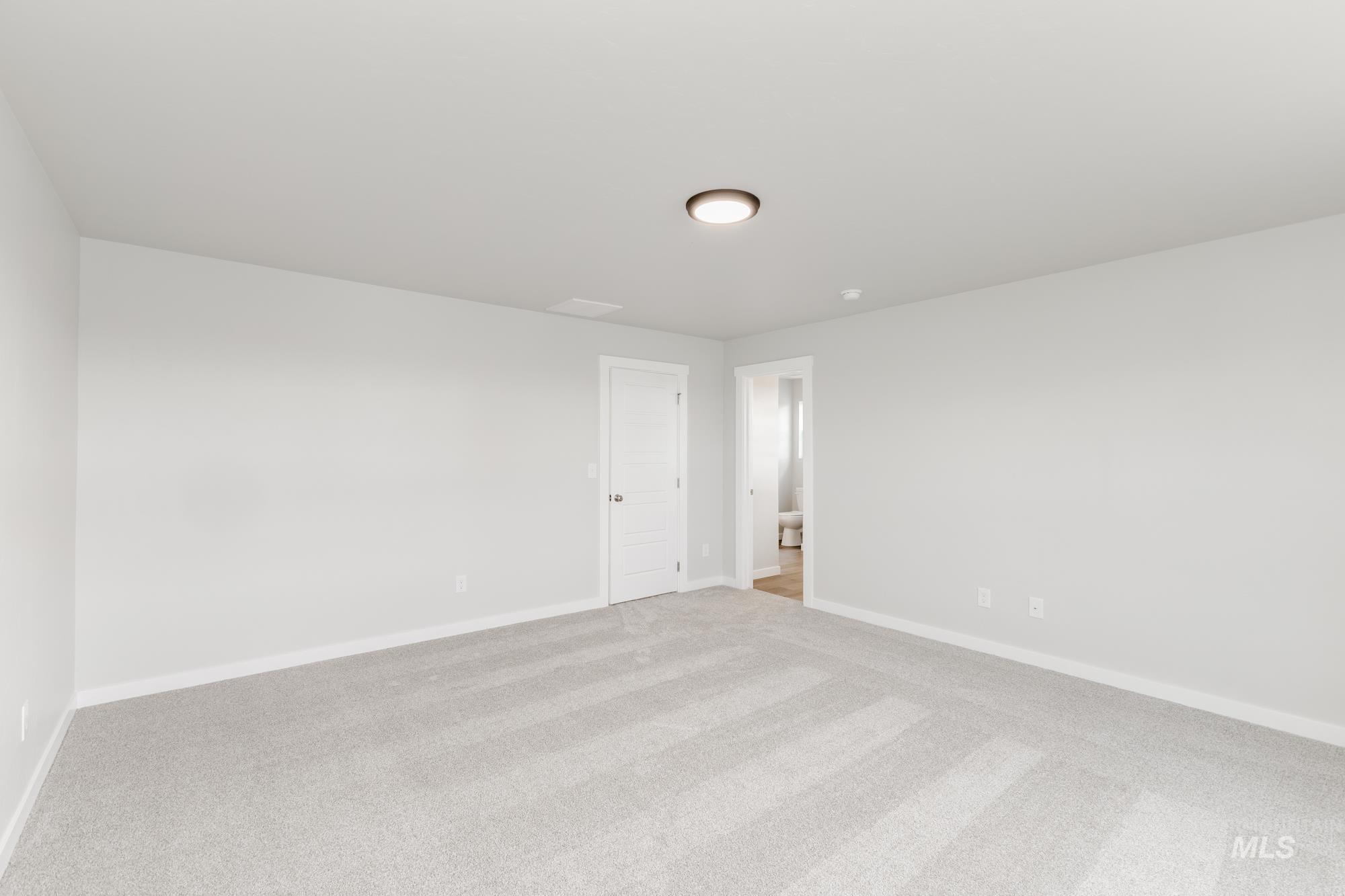 903 North Mirror Creek Way Meridian, ID 83642 - Photo 20 of 24 Carpeted spare room featuring baseboards