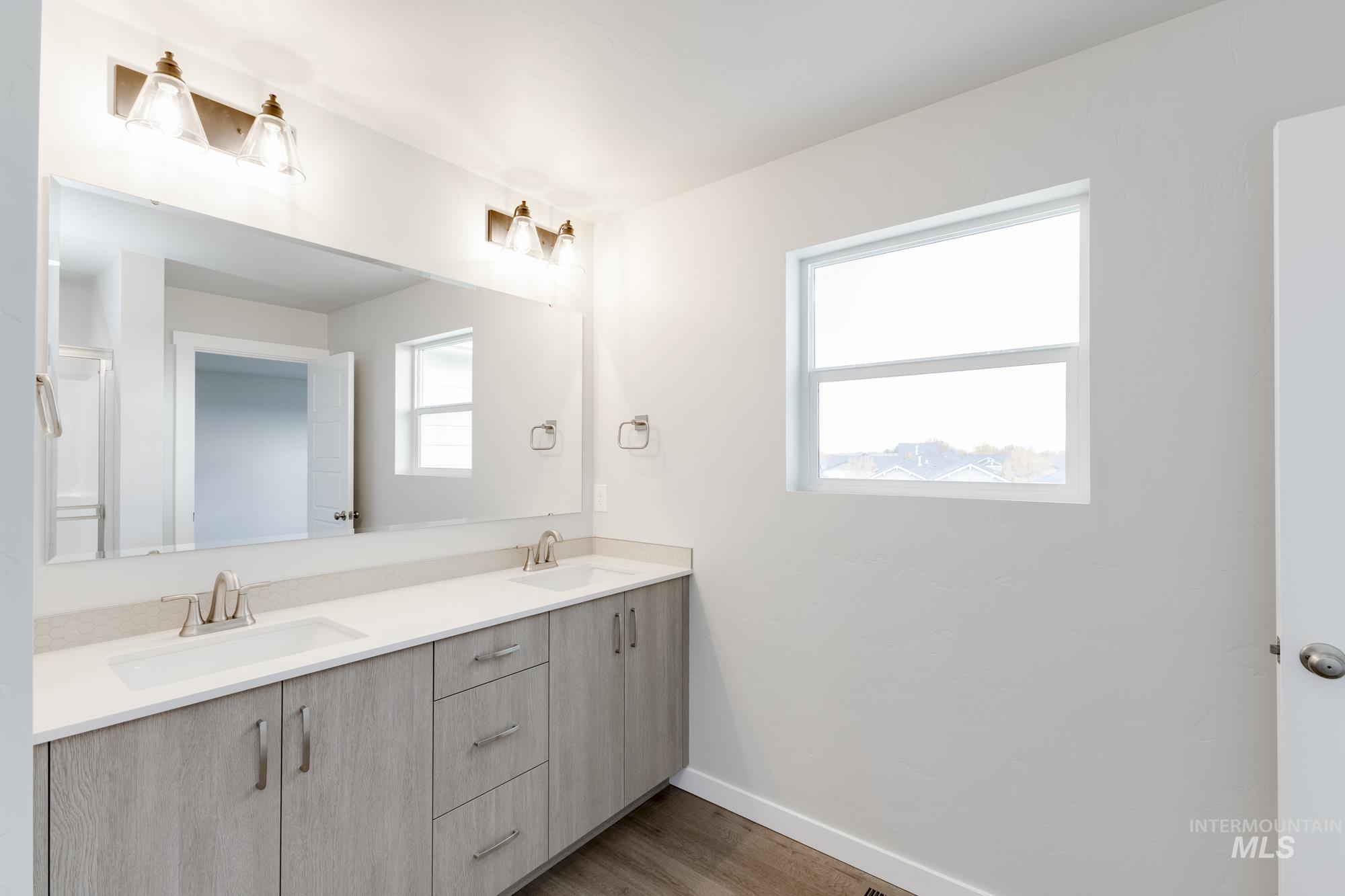 903 North Mirror Creek Way Meridian, ID 83642 - Photo 21 of 24 Bathroom with double vanity and light wood finished floors