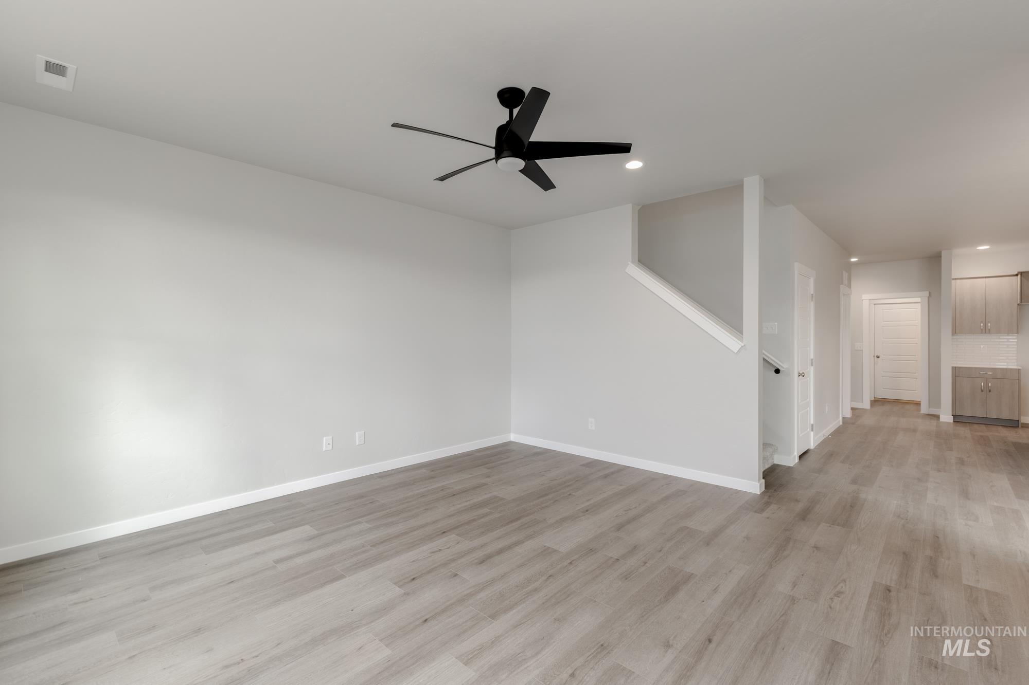 903 North Mirror Creek Way Meridian, ID 83642 - Photo 8 of 24 Unfurnished room with light wood-type flooring, a ceiling fan, and recessed lighting