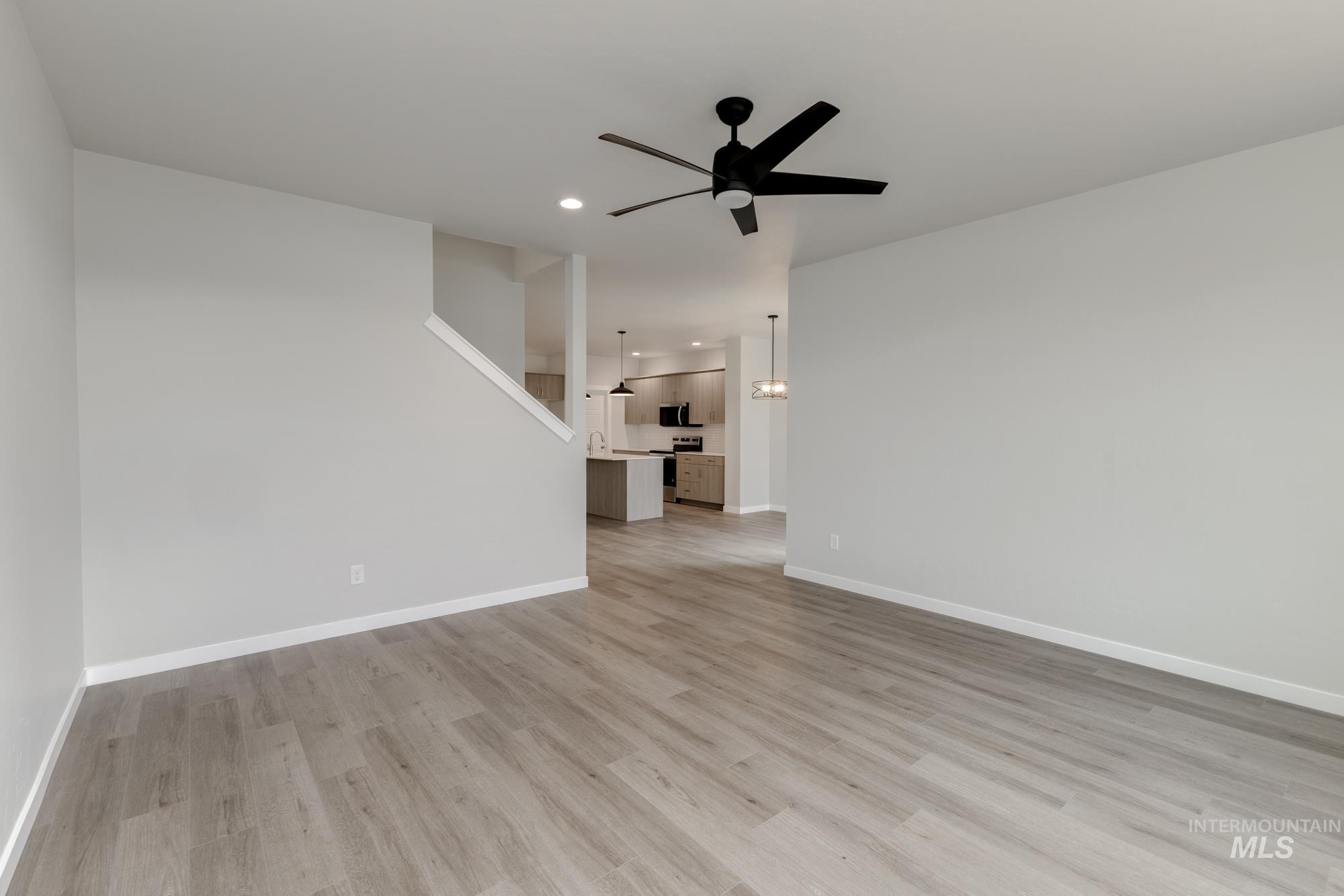903 North Mirror Creek Way Meridian, ID 83642 - Photo 9 of 24 Unfurnished living room featuring a ceiling fan, recessed lighting, and light wood finished floors