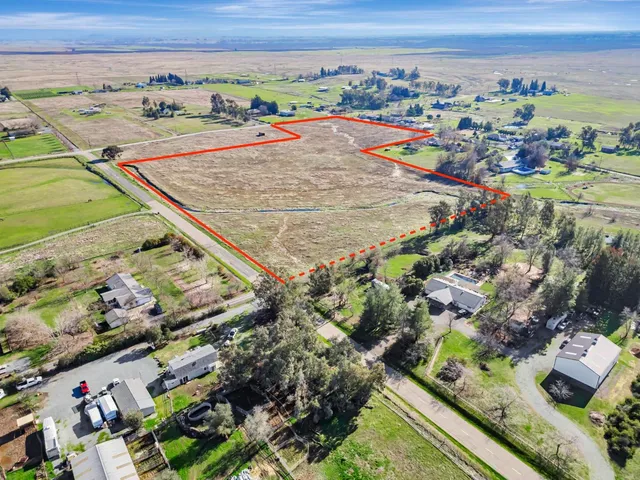 an aerial view of a pool an outdoor space and seating area