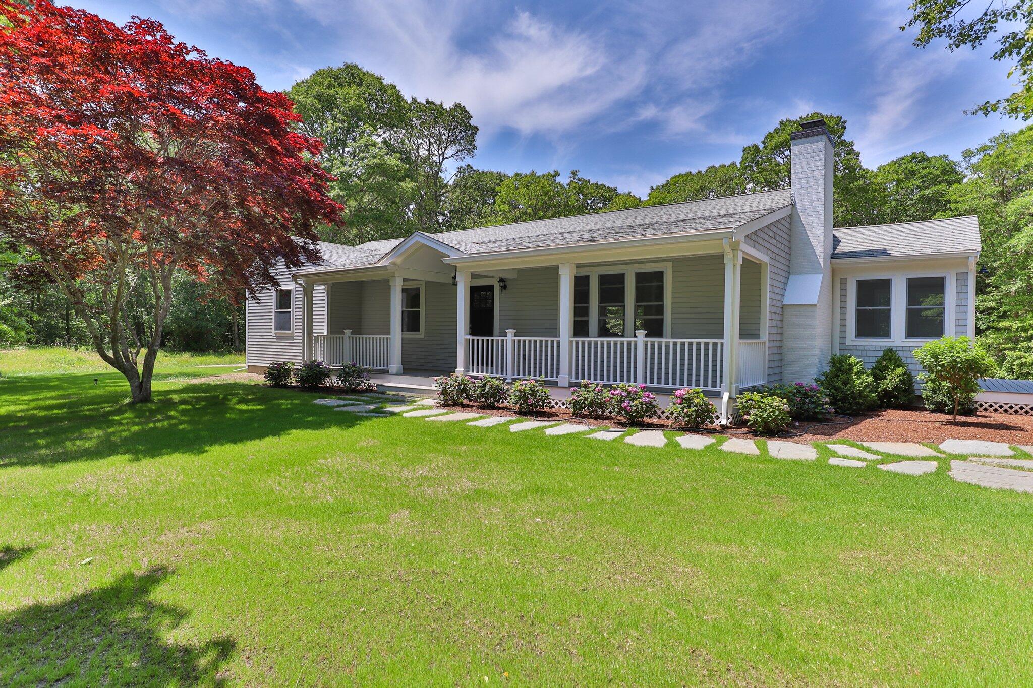 a front view of house with yard and green space