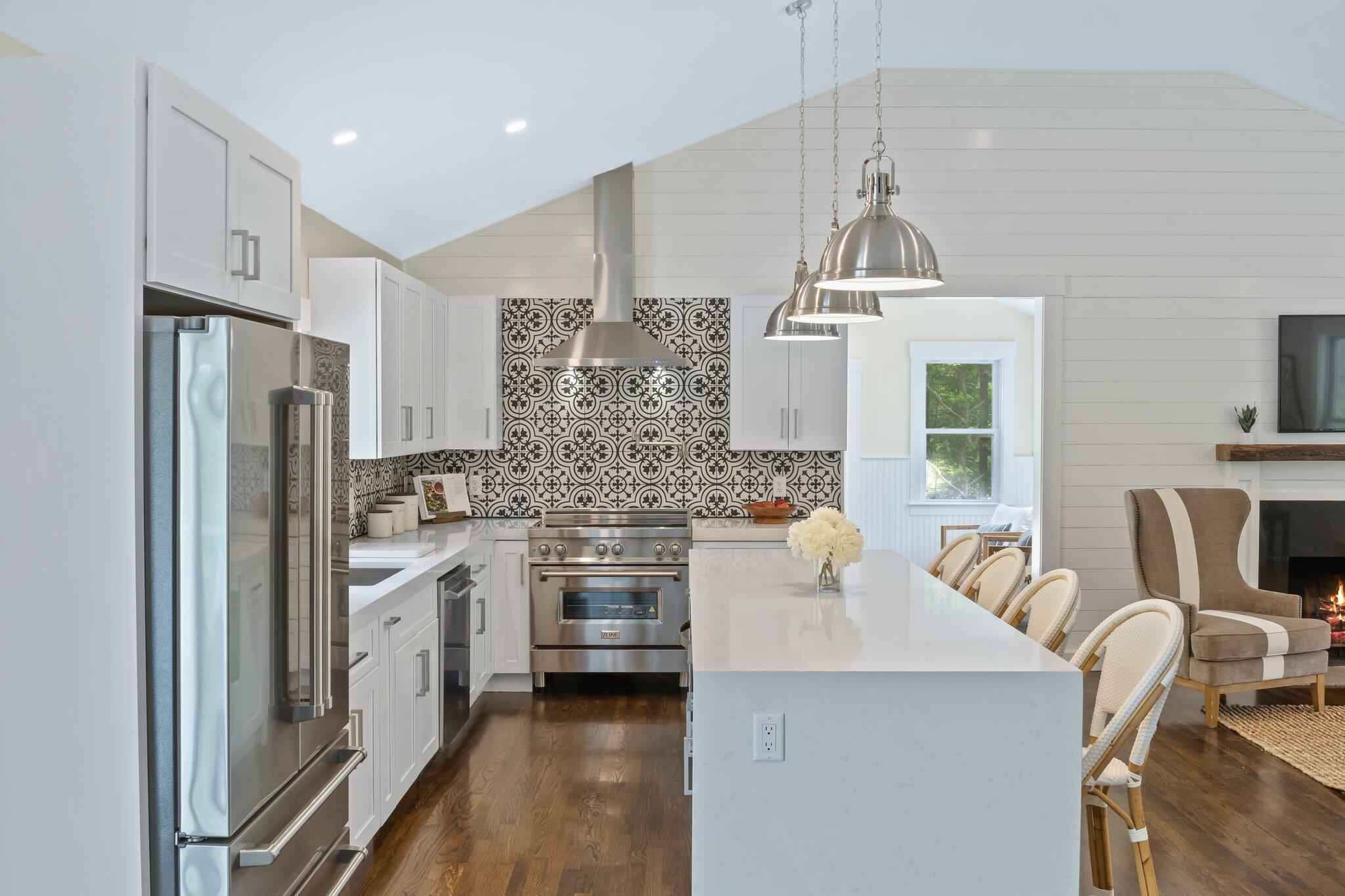 169 Old Post Road Centerville, MA 02632 - Photo 11 of 53 a kitchen with white cabinets and stainless steel appliances