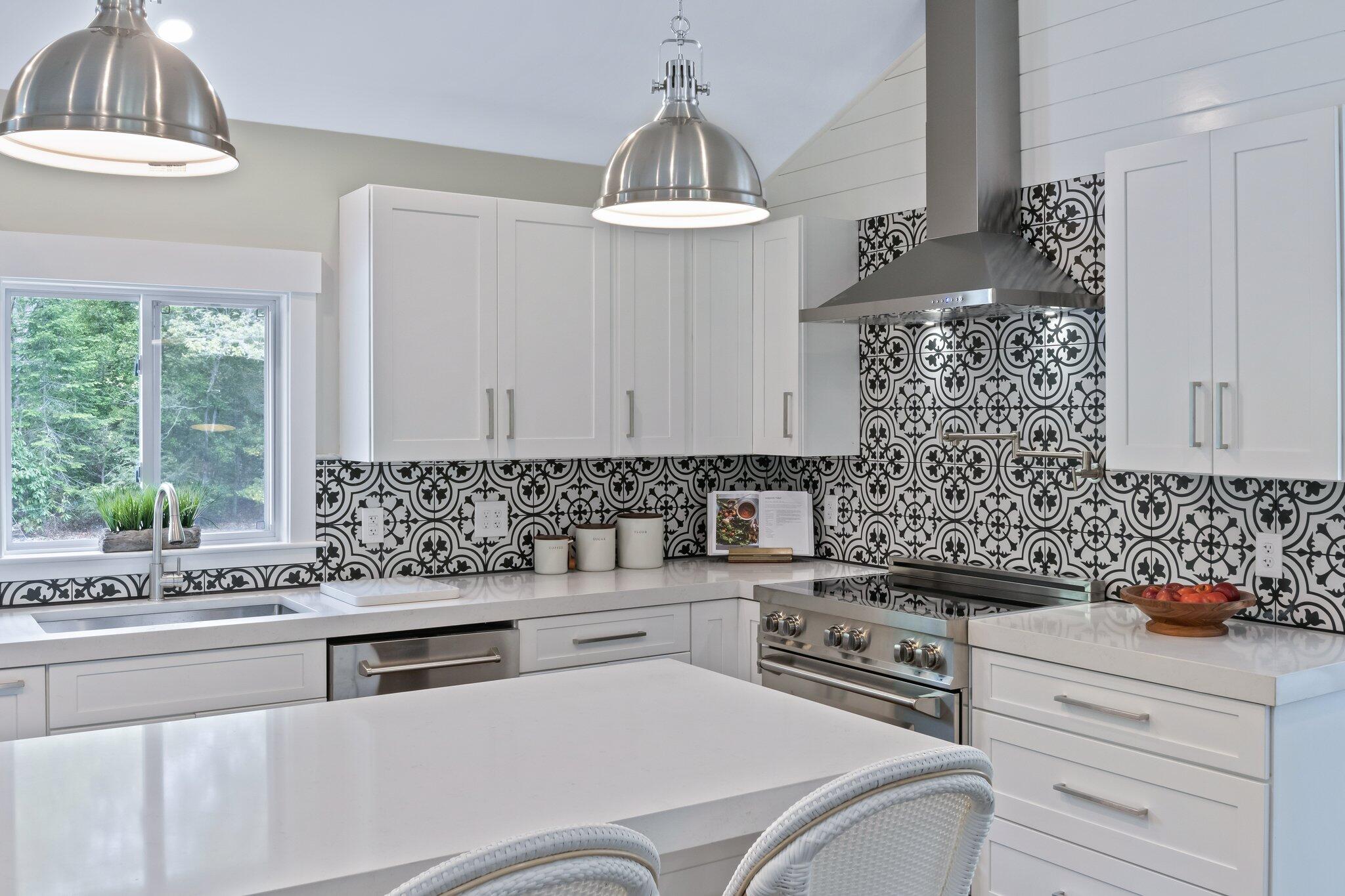 169 Old Post Road Centerville, MA 02632 - Photo 16 of 53 a kitchen with stainless steel appliances a sink stove and cabinets