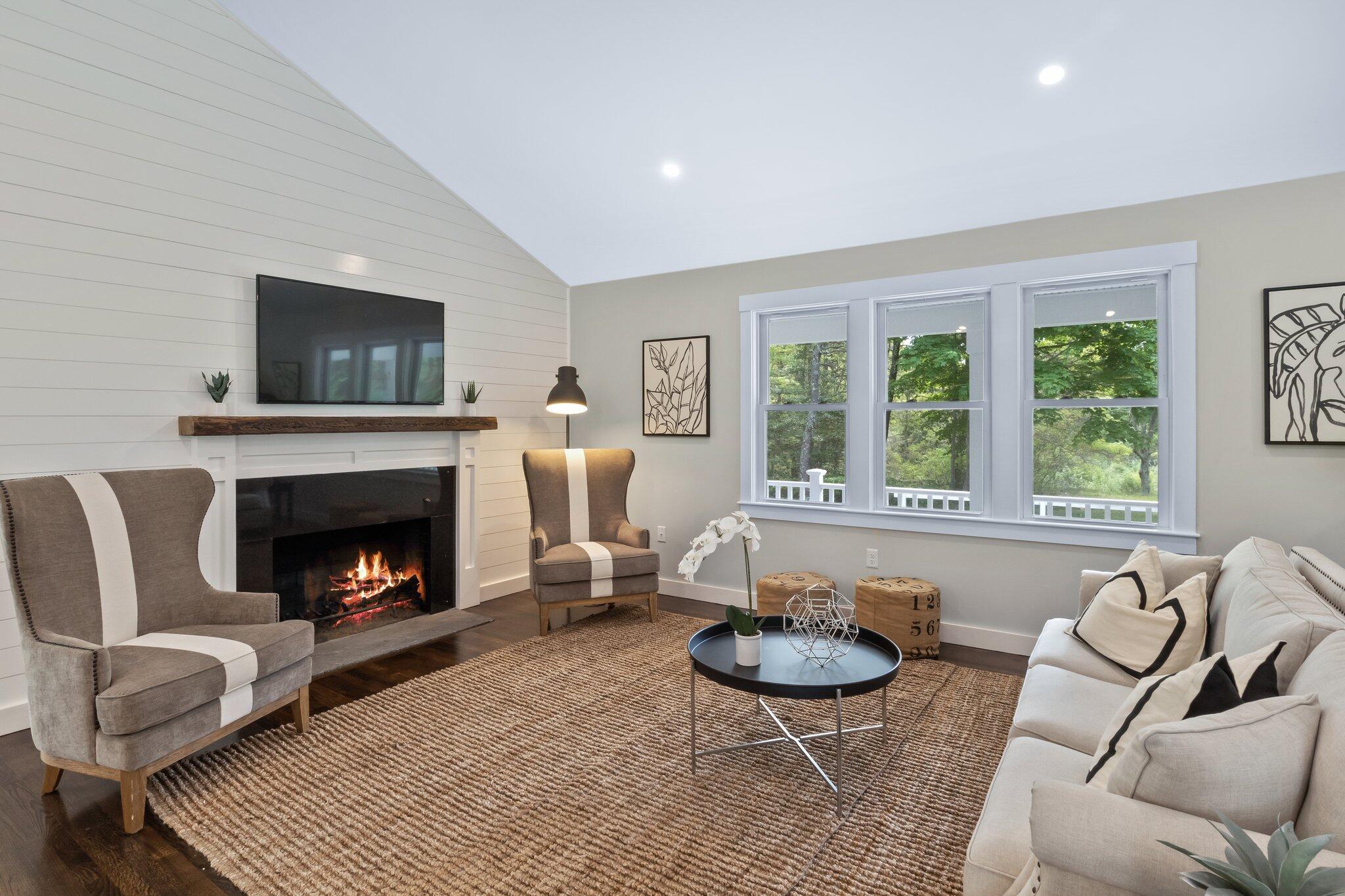 169 Old Post Road Centerville, MA 02632 - Photo 19 of 53 a living room with furniture a flat screen tv and a fireplace