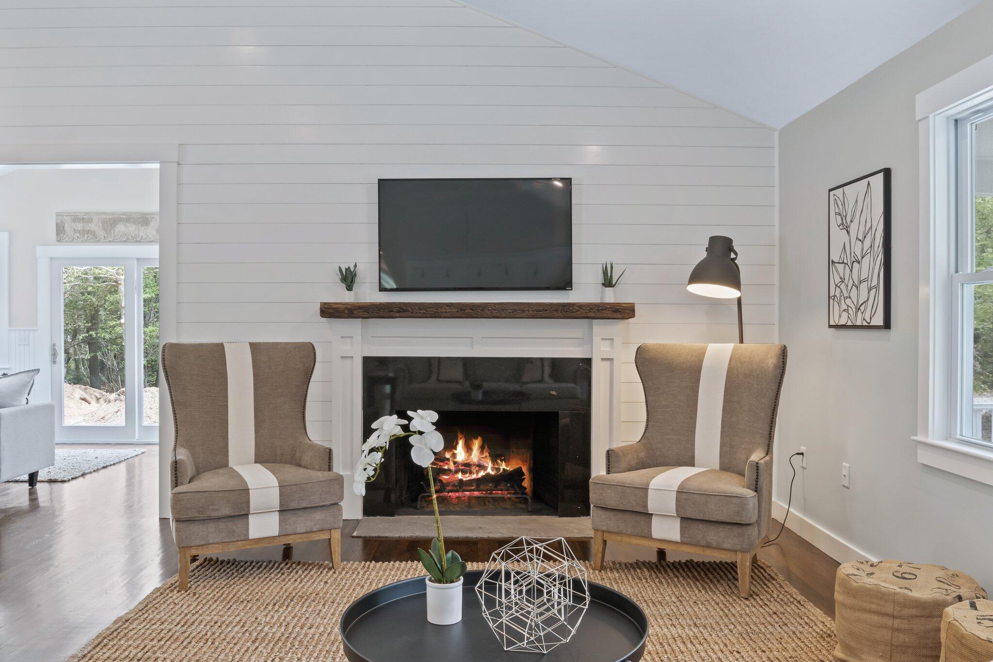 169 Old Post Road Centerville, MA 02632 - Photo 20 of 53 a living room with furniture a flat screen tv and a fireplace