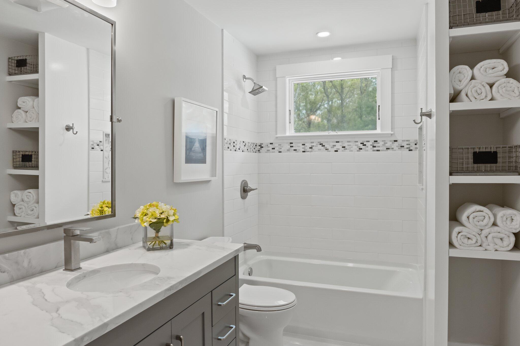 169 Old Post Road Centerville, MA 02632 - Photo 27 of 53 a bathroom with a granite countertop sink a toilet and shower