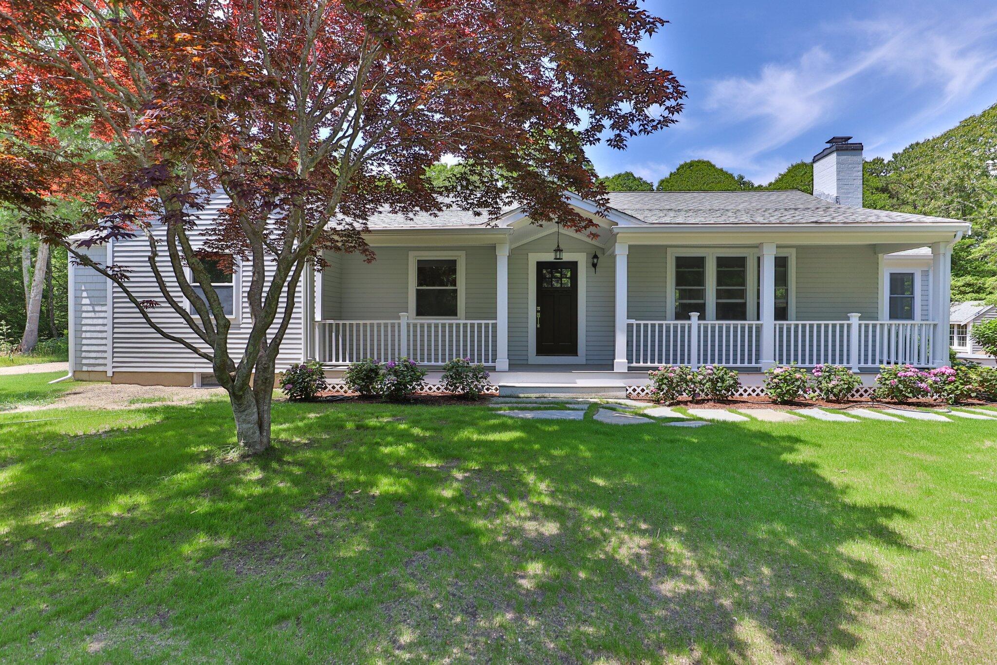 169 Old Post Road Centerville, MA 02632 - Photo 42 of 53 a front view of house with yard and green space