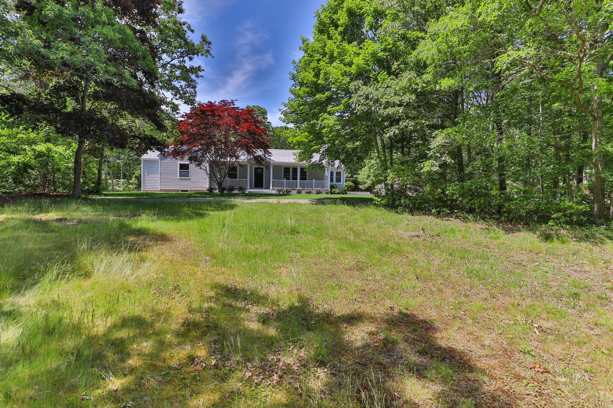 169 Old Post Road Centerville, MA 02632 - Photo 44 of 53 a view of a house with a big yard and large trees
