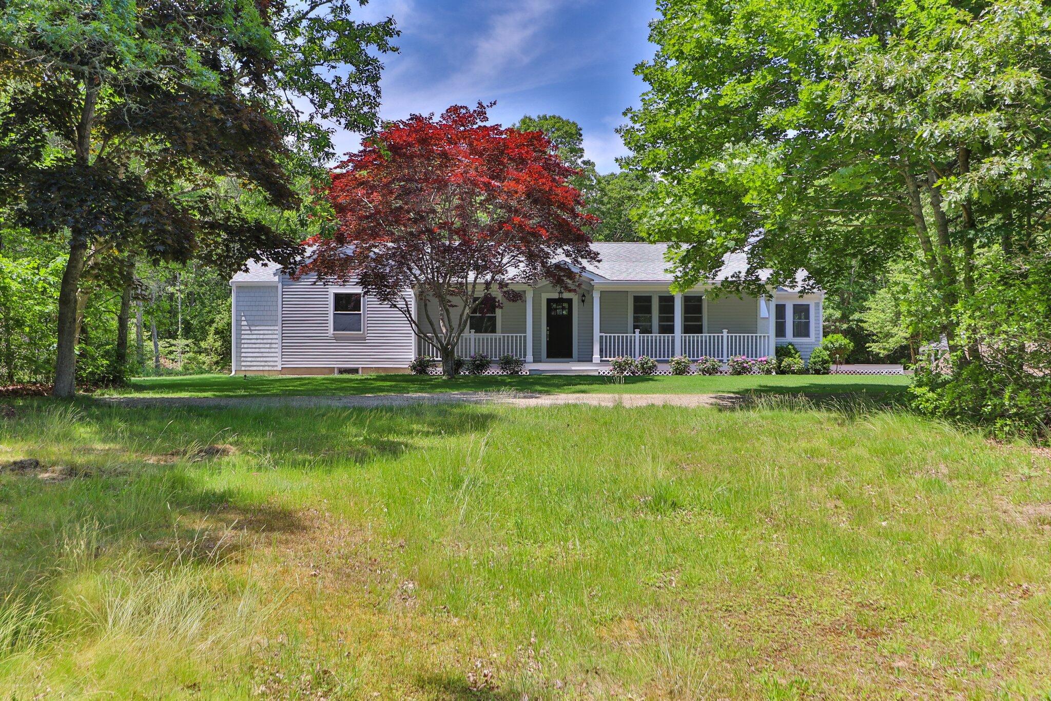 169 Old Post Road Centerville, MA 02632 - Photo 45 of 53 a front view of a house with swimming pool and green space