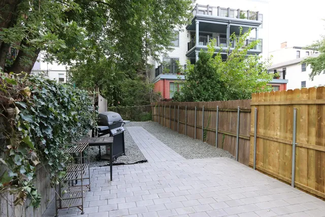 a view of a chairs and table in backyard