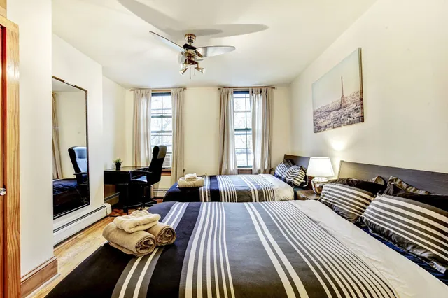 a bedroom with furniture and wooden floor