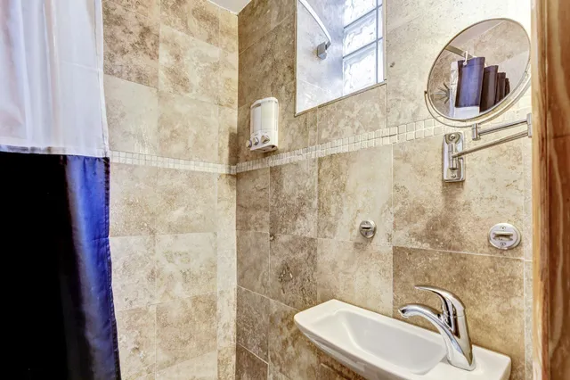 a bathroom with a sink a mirror and a shower