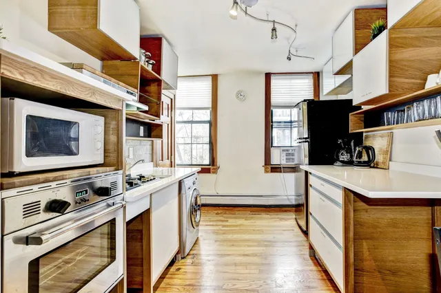 a kitchen with stainless steel appliances a stove a sink and a refrigerator